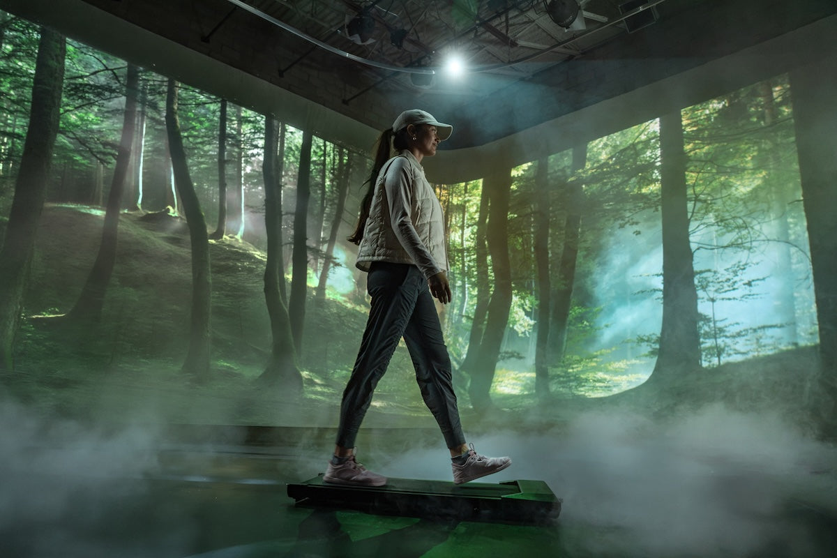 A woman walking in Pacer Lite shoes through the forest