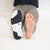 One foot with shoe, one bare foot