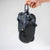Xero Shoes Literary Sport Genesis Navy Strap Black Sandal with a Hand Holding the Pair of Sandals by a Carabiner