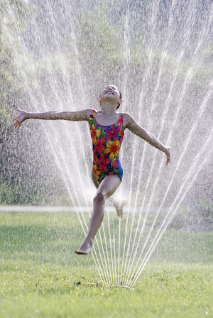 running barefoot through the sprinkler