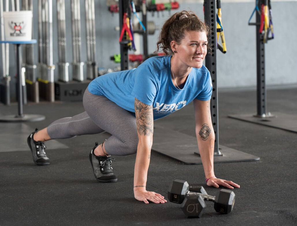 Woman wearing 360 workout shoes and workout clothes exercising in a gym