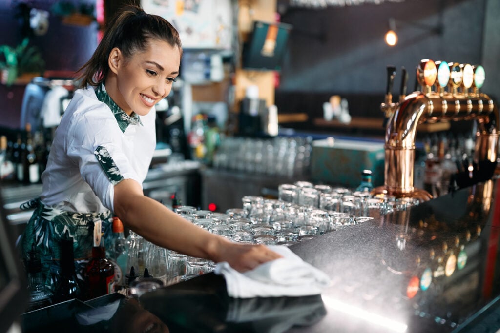 A bartender cleaning the bar