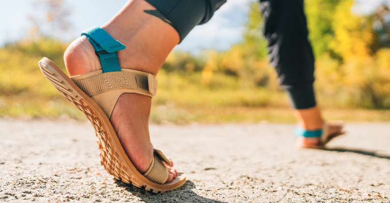 D-Trail sandals on a sandy, gravel trail.