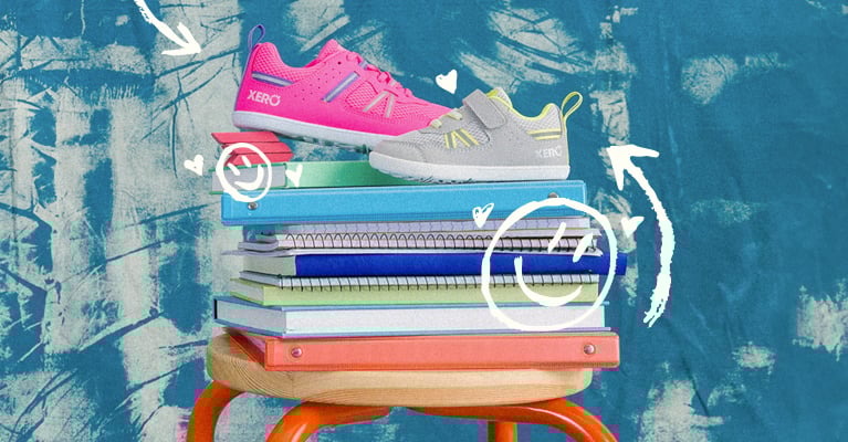 Prio Big Kids Pink and Prio Little Kids Lunar on a stack of notebooks for school